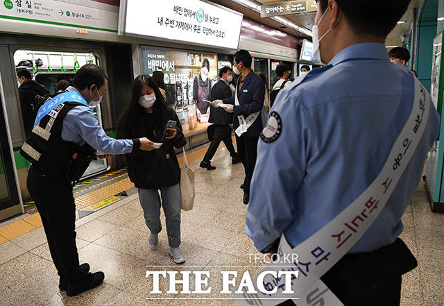 코로나19 예방을 위한 마스크 착용 의무화 첫날인 13일 오전 서울 송파구 잠실역에서 지하철 보안관들이 출근길에 나선 시민들에게 마스크 착용 계도에 나서고 있다. /배정한 기자