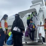 Jemaah haji kloter 01-BTJ Debarkasi Aceh turun dari Pesawat Garuda Indonesia saat tiba di Bandara Internasional Sultan Iskandar Muda (SIM) Aceh Besar, Aceh, Rabu (10/7/2024). Foto: ANTARA/Khalis Surry