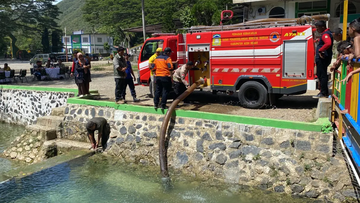 Petugas mengambil air dari kolam Mata Ie untuk didistribusikan ke gampong-gampong di Lhoknga yang kekeringan sumber air tanah. Foto: acehbesarkab.go.id