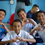 Bayu Satria (kaos biru) bersama anak-anak sekolah. Foto: unicef.org