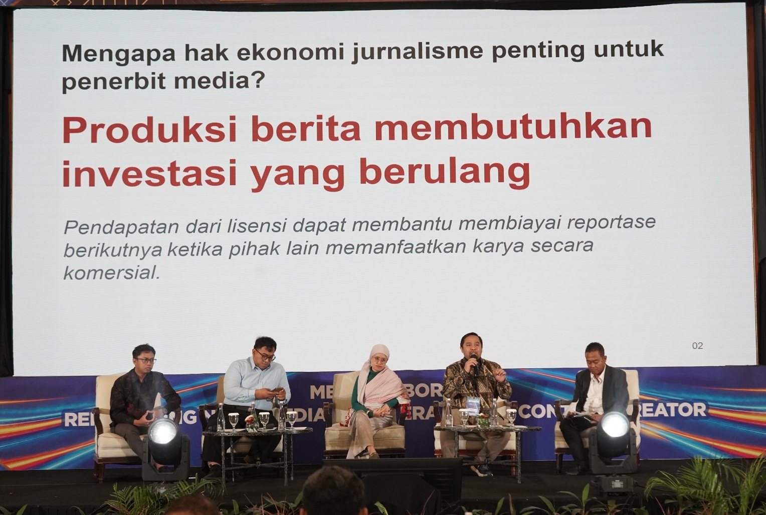 Lima panelis dan moderator duduk di atas panggung dalam sesi diskusi panel IDMC 2026, di bawah layar besar bertuliskan "Mengapa hak ekonomi jurnalisme penting untuk penerbit media?".